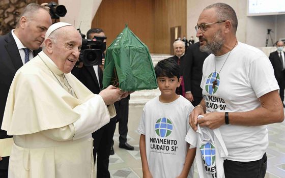 Pope Francis accepts the gift of a handmade "Abraham's tent" during his general audience in the Paul VI hall at the Vatican Sept. 1. The gift was given by members of the Laudato Si' Movement. (CNS/Vatican Media)